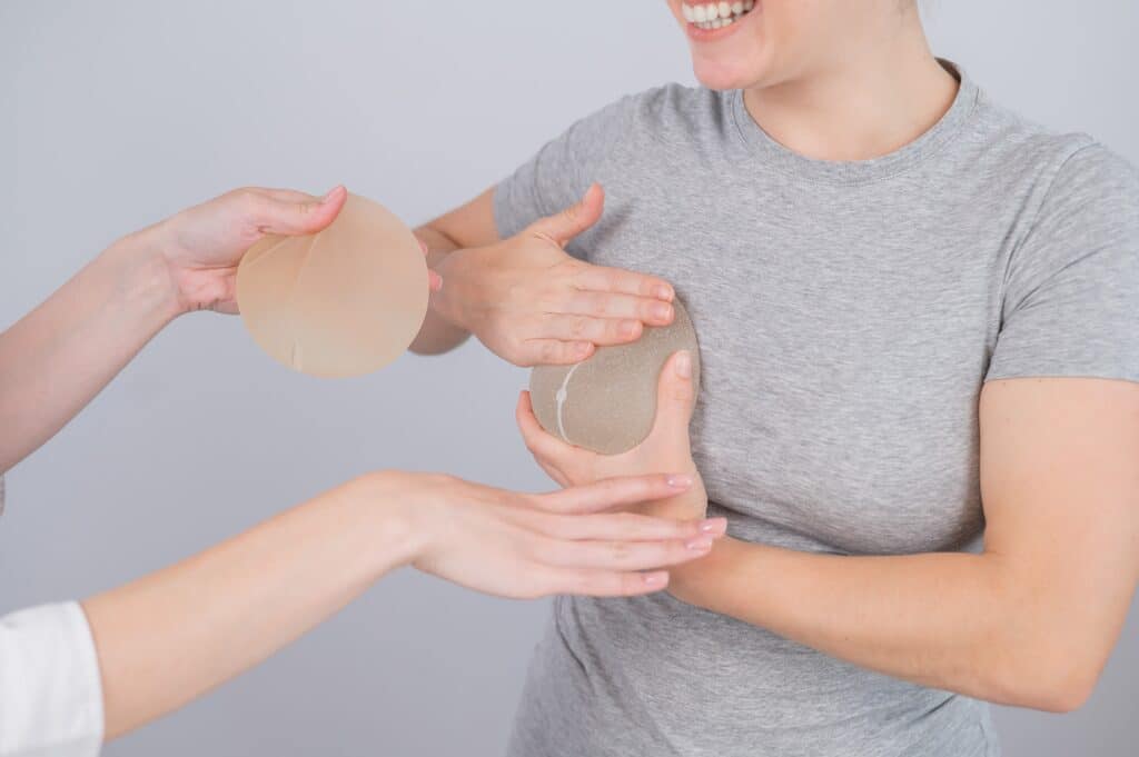 Woman having a consultation with her plastic surgeon about a breast lift with implants